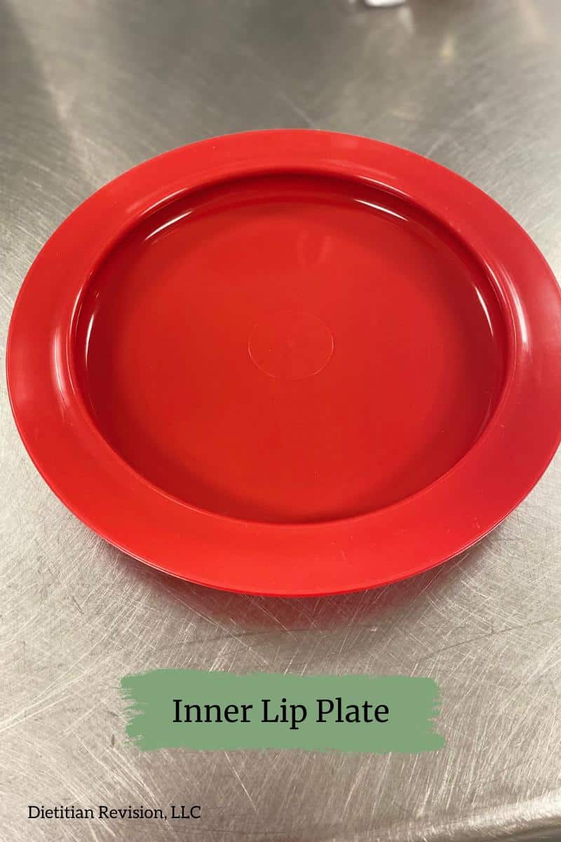 Red inner lip plate on stainless steel surface. 