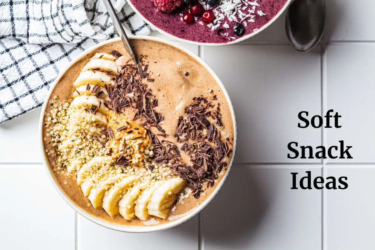 Smoothie bowl sitting on white counter top with towel in the background and black writing saying soft snack ideas.