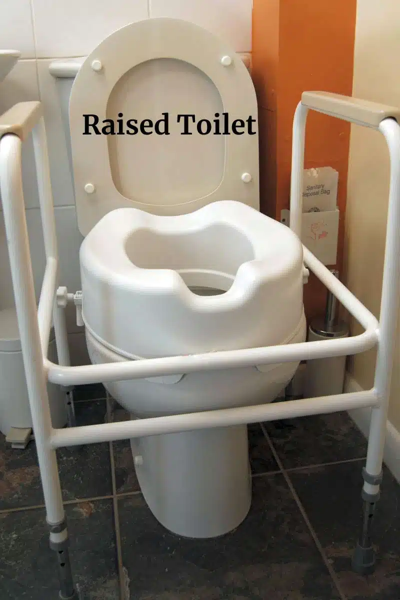 Toilet riser with bars on top a toilet.